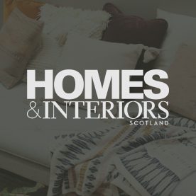 HIS Logo Image Overlay homes and interiors logo over an image of a sofa with cushions