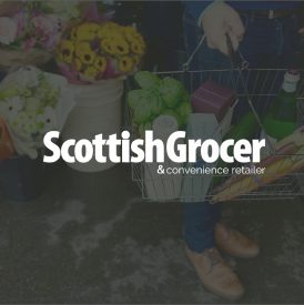 Scottish Grocer Logo Image Overlay (1) scottish grocer logo over an image of a person holding a shopping basket filled with groceries